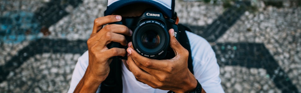 trabalhar viajando como Fotografo: um homem com uma máquina de fotografia nas mãos tirando fotos