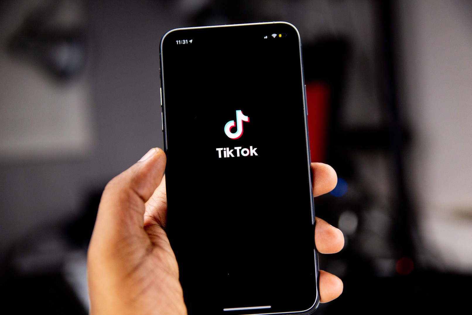 Una de las redes sociales más usadas es TikTok y se muestra su logotipo en esta imagen dentro de un smartphone sostenido por una persona