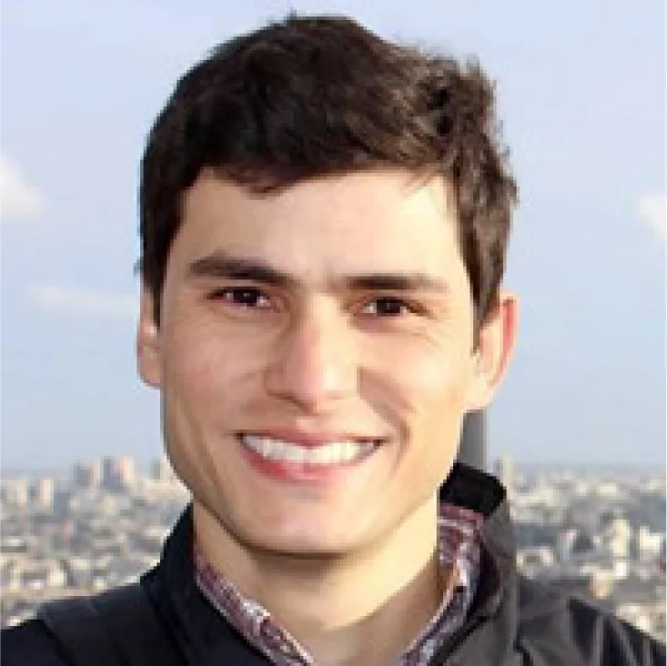 Hands typing at a laptop. On the screen, there is a page showing Hotmart Marketplace with courses to buy.