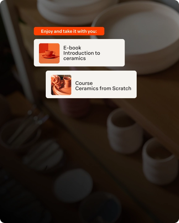 Mobile screen showing an offer for an e-book about an introduction to ceramics, next to white ceramic utensils and a cup on the table